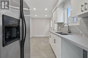 Mississauga (Meadowvale) apartment for rent - A modern kitchen with a stainless steel refrigerator and marble countertops.