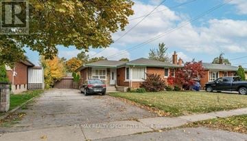 St. Catharines (Bunting/Linwell) duplex for rent - A house with a driveway and a car parked in front.