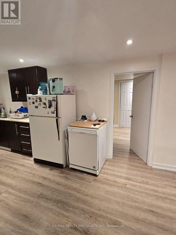 St. Catharines (Bunting/Linwell) duplex for rent - A white refrigerator and dishwasher in a kitchen.