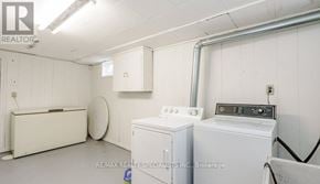 St. Catharines (Bunting/Linwell) duplex for rent - A white washing machine and dryer in a laundry room.