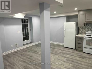 Brampton (Credit Valley) apartment for rent - A kitchen with a white refrigerator and a grey floor.