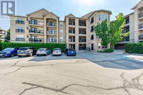 Burlington (Uptown) condo for rent - A parking lot in front of a building with cars parked.