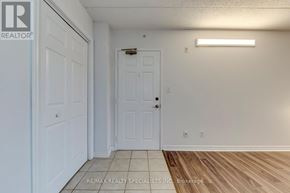 Burlington (Uptown) condo for rent - A white door is in a room with a wooden floor.