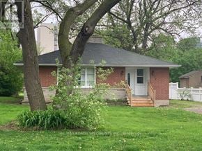 Burlington (Brant) apartment for rent - A small house with a white door and a tree in front.