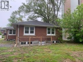 Burlington (Brant) apartment for rent - A house with a red brick exterior and a white window is for sale.