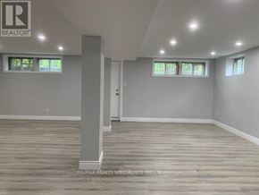 Burlington (Brant) apartment for rent - A spacious room with wooden flooring and white walls, ready for a new tenant.