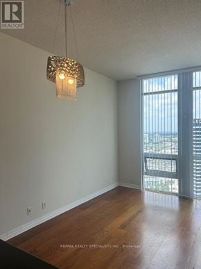 Mississauga (City Centre) condo for rent - A room with a wooden floor and a chandelier hanging from the ceiling.