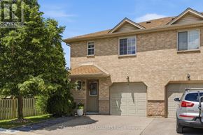 Hamilton (Stoney Creek Mountain) townhouse for rent - A house with a garage and a car parked in front.