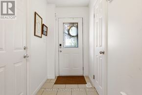 Hamilton (Stoney Creek Mountain) townhouse for rent - A hallway with white walls and a brown doormat.