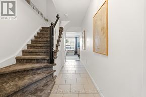 Hamilton (Stoney Creek Mountain) townhouse for rent - A hallway with a staircase and a painting on the wall.