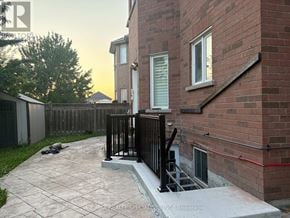 Mississauga (Meadowvale Village) apartment for rent - A brick house with a black railing and a concrete walkway.
