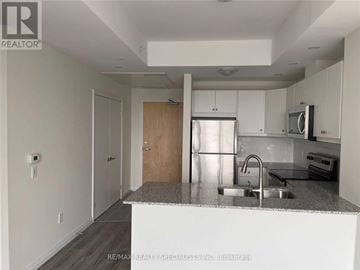 Kitchener condo for rent - A kitchen with white cabinets and a granite countertop.