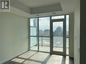 Kitchener condo for rent - A room with a large window and a view of the city.