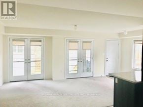 Brampton (Northwest Brampton) townhouse for rent - A room with white walls and a carpeted floor with a black counter on the right side.