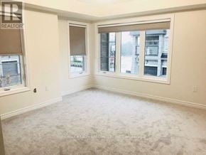 Brampton (Northwest Brampton) townhouse for rent - A room with a carpeted floor and a window with blinds.