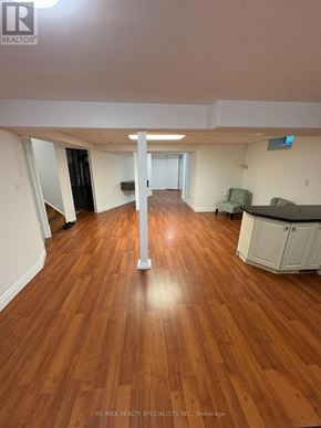 Hamilton (Meadowlands) apartment for rent - A room with wooden floors and white walls, with a kitchen area visible in the background.