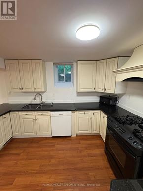 Hamilton (Meadowlands) apartment for rent - A kitchen with wooden floors and white cabinets.