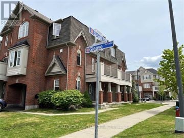 Milton (Ha Harrison) townhouse for rent - A street sign for Terrace and Cleveland is in front of a brick building.