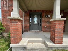 Milton (Ha Harrison) townhouse for rent - A black door is flanked by two pillars and a brick wall.