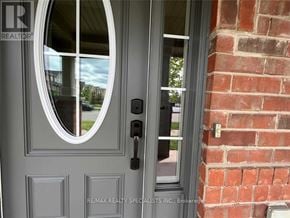 Milton (Ha Harrison) townhouse for rent - A grey door with a glass window and a handle.