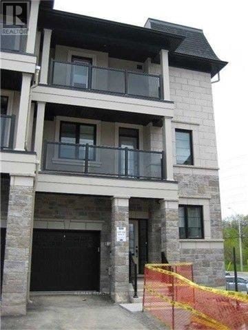 Mississauga (Lakeview) townhouse for rent - A building with a balcony and a black door.