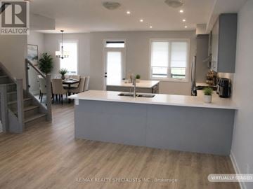 Mississauga (Lakeview) townhouse for rent - A modern kitchen with a dining table and chairs.