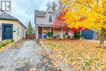 Burlington (Brant) apartment for rent - A house with a blue door and a tree with yellow leaves in front.