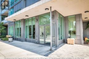 Mississauga (City Centre) condo for rent - A modern building entrance with glass doors and a number 3525 on the glass.