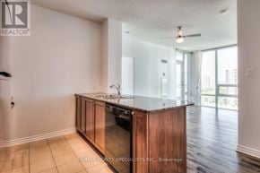 Mississauga (City Centre) condo for rent - A kitchen with wooden cabinets and a marble countertop.