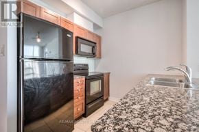 Mississauga (City Centre) condo for rent - A kitchen with a black fridge, microwave, and oven.