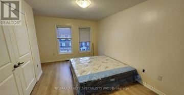 Brampton (Northwest Brampton) townhouse for rent - A bedroom with a bed, a window, and a door.