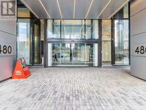 Toronto (Waterfront Communities) condo for rent - The entrance to a building with a glass door and a sign that reads "REALTOR".