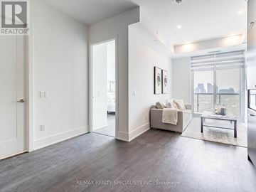 Toronto (Waterfront Communities) condo for rent - A spacious living room with a couch and a coffee table.