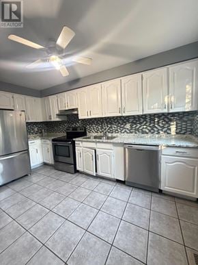 Brampton (Fletcher's Creek Village) townhouse for rent - A kitchen with white cabinets and a black and white backsplash.
