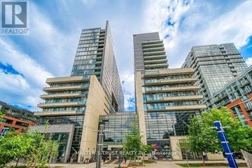 Toronto (Little Portugal) condo for rent - A building with the sign Master Strust Realty Inc Brokerage in front of it.