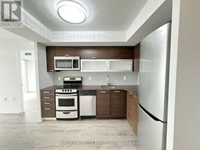 Toronto (Little Portugal) condo for rent - A kitchen with a refrigerator, microwave, oven, and sink.