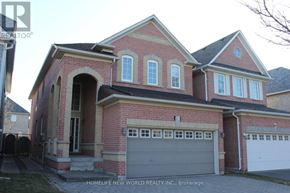 Markham (Berczy) apartment for rent - A brick house with a garage door is for sale.