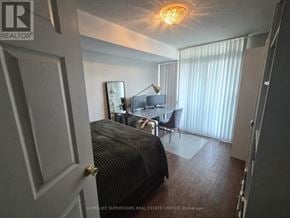 Toronto (Willowdale East) condo for rent - A bedroom with a bed, desk, and chair.