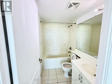 Toronto (Bendale) condo for rent - A white bathroom with a toilet, sink, and bathtub.