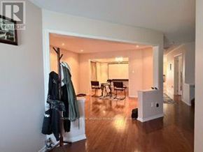 Oshawa (Taunton) apartment for rent - A room with a wooden floor and a white wall with a coat rack and a chair.