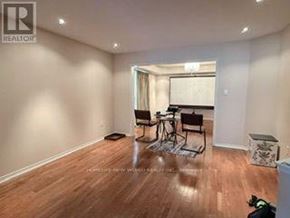 Oshawa (Taunton) apartment for rent - A room with wooden flooring and a bicycle in it.