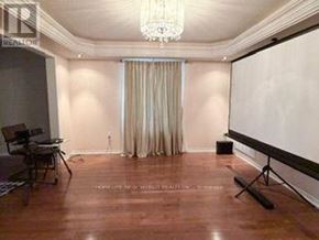 Oshawa (Taunton) apartment for rent - A room with a whiteboard, a chair, and a chandelier.