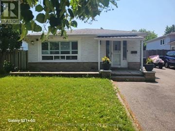 Toronto (Malvern) apartment for rent - A white house with a grey roof and a sign that says "REALTOR" in the front yard.