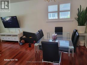 Toronto (Malvern) apartment for rent - A living room with a TV, a couch, a chair, and a potted plant.