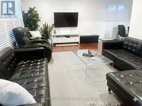 Toronto (Malvern) apartment for rent - A living room with black leather couches and a glass coffee table.