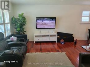 Toronto (Malvern) apartment for rent - A living room with a flat screen TV and a leather couch.