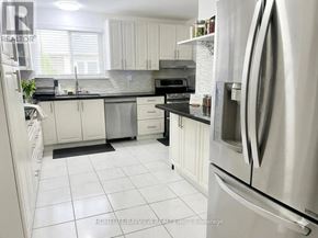 Toronto (Malvern) apartment for rent - A kitchen with white cabinets and a stainless steel refrigerator.