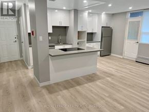 Mississauga (Applewood) condo for rent - A modern kitchen with white cabinets and a central island.