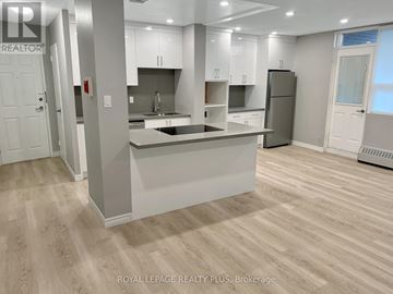 Mississauga (Applewood) condo for rent - A modern kitchen with white cabinets and a central island.