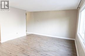 St. Catharines (Port Dalhousie) apartment for rent - A white kitchen with a stove and cabinets.
